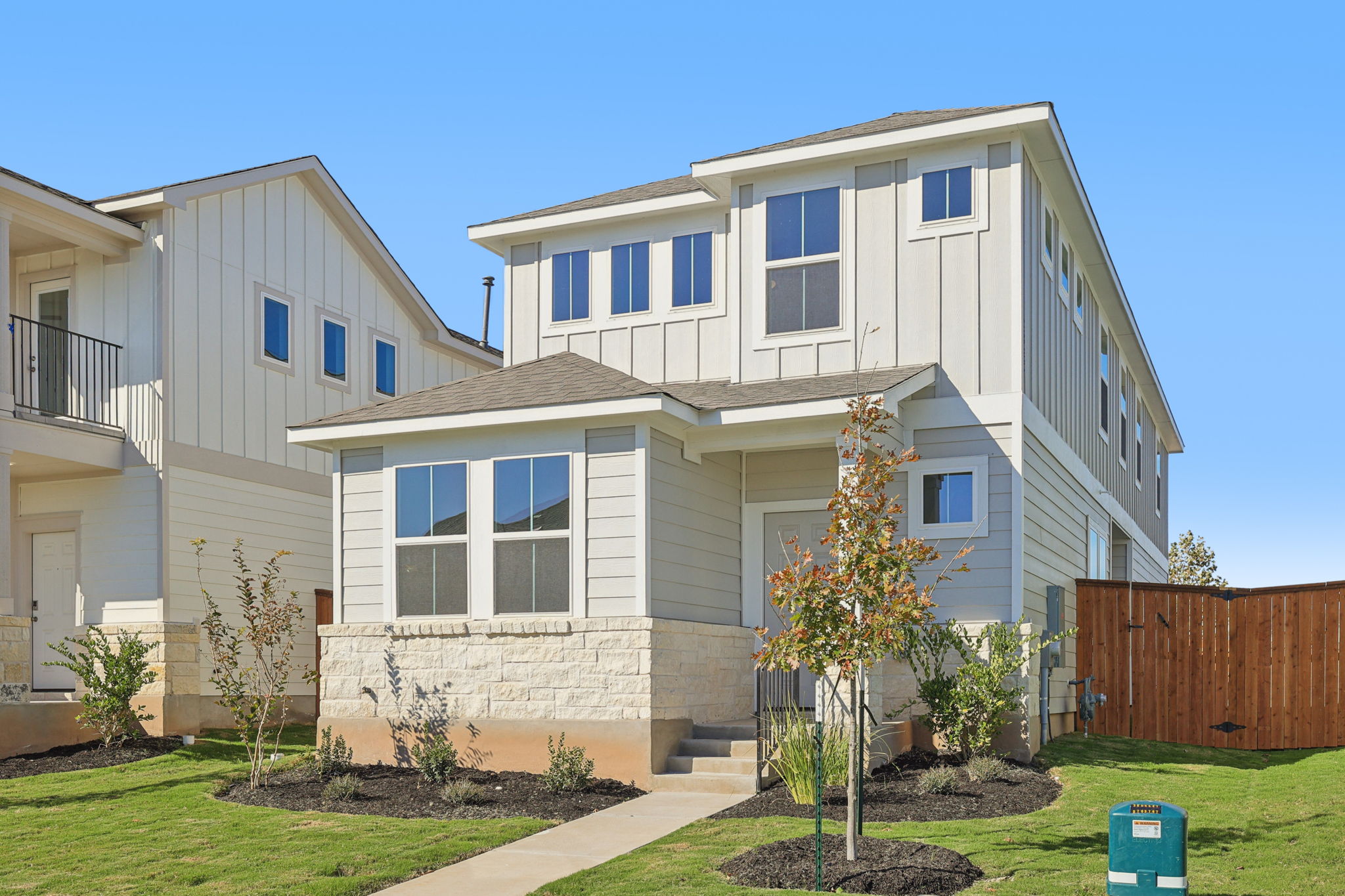 A white house with a fence.