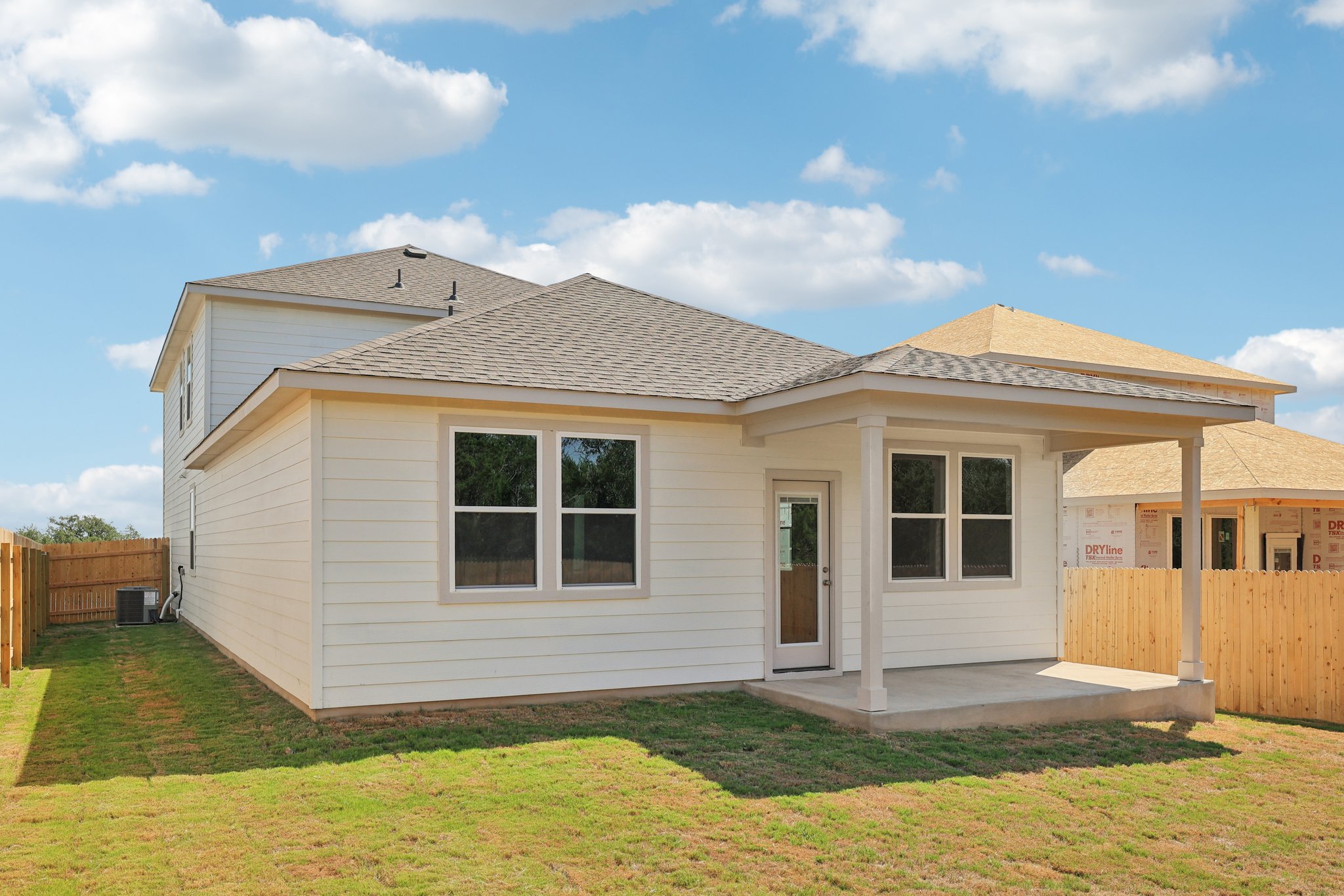 A house with a fence and grass.