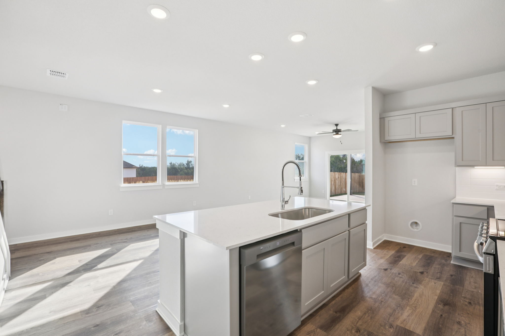 A kitchen with white cabinets.