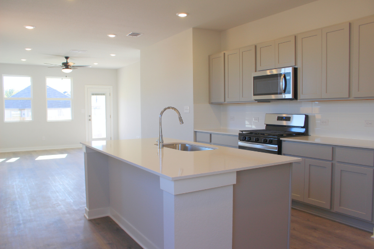 A kitchen with white cabinets.