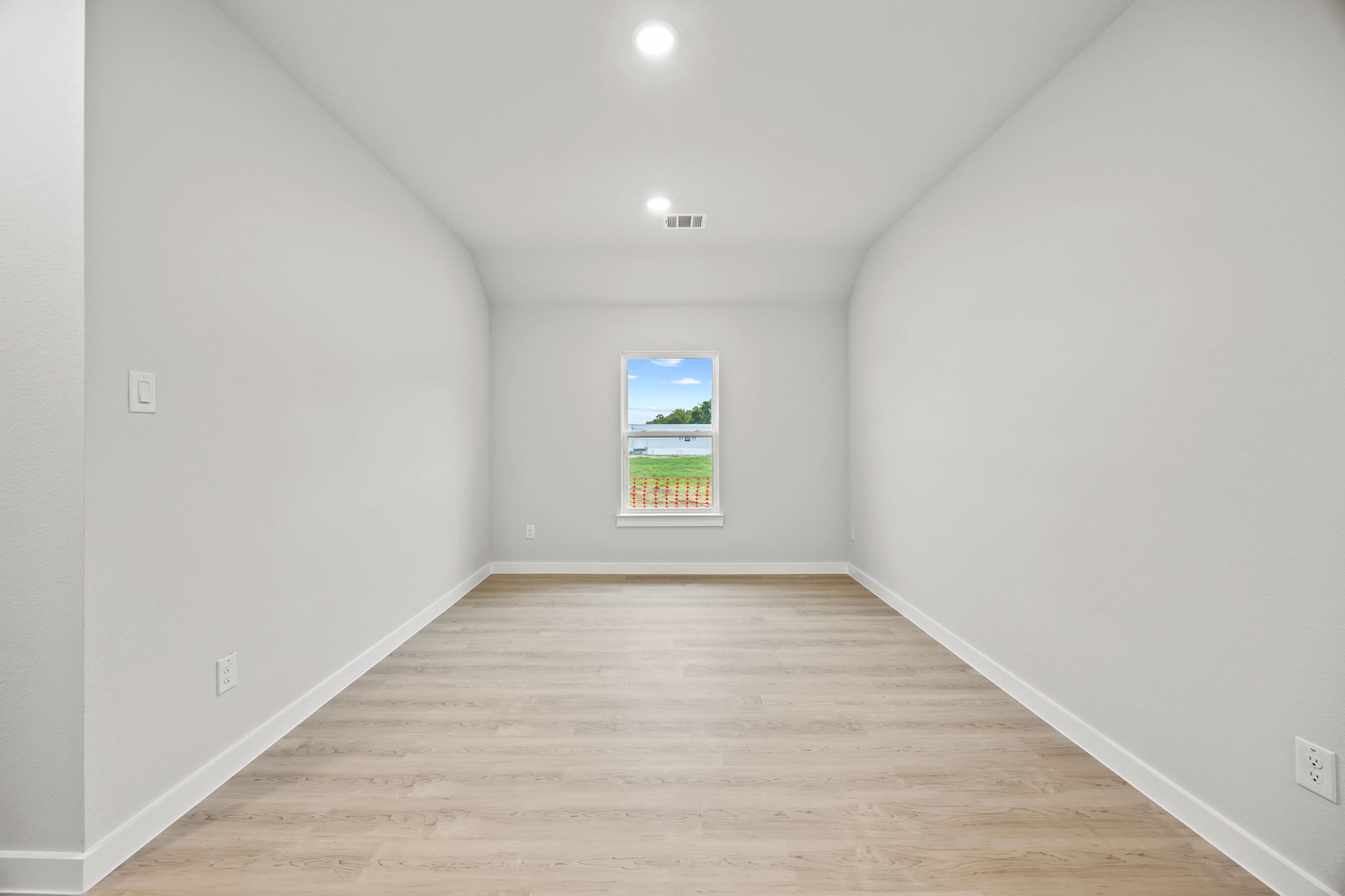 A hallway with white walls.