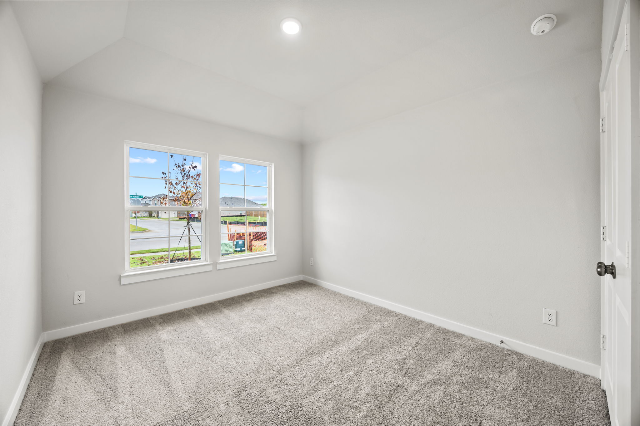 A room with a carpet and a window.