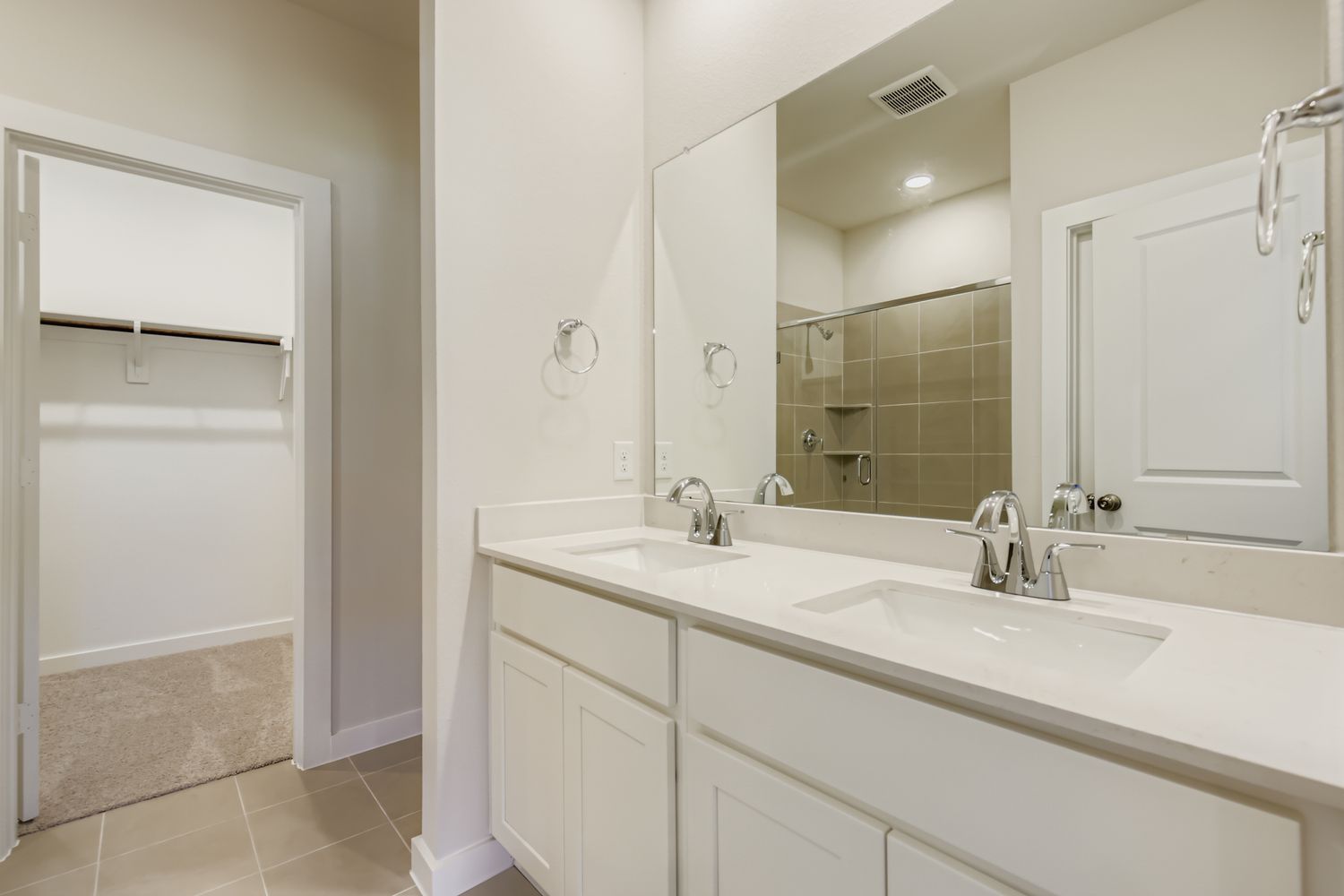 A bathroom with a large mirror.