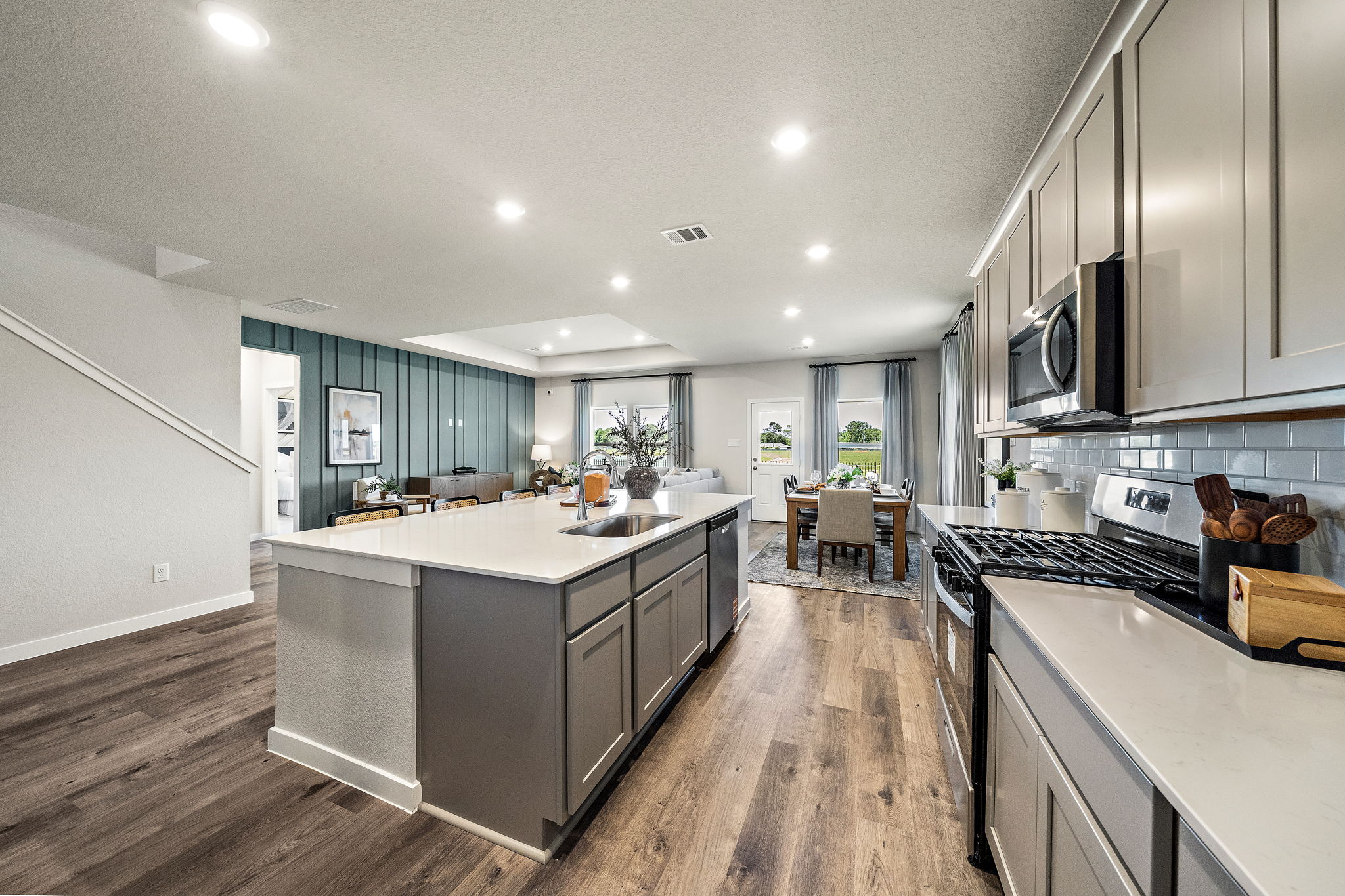 A kitchen with a wood floor.