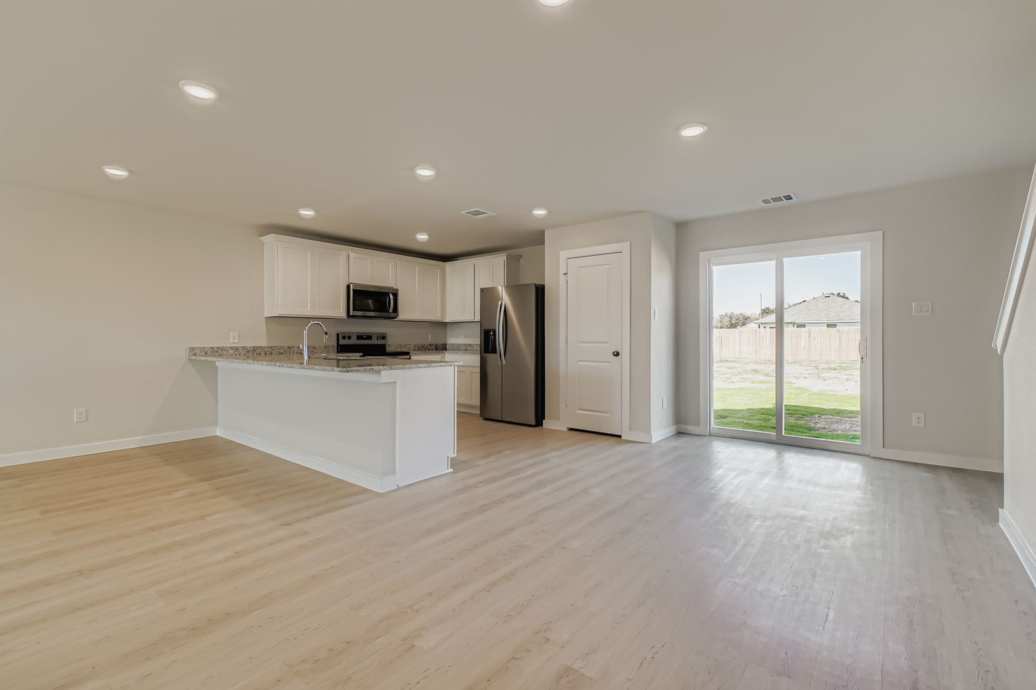 A kitchen with a wood floor.