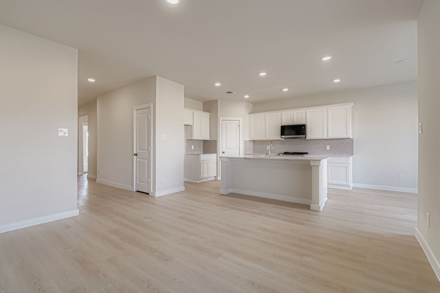 A large kitchen with white cabinets.