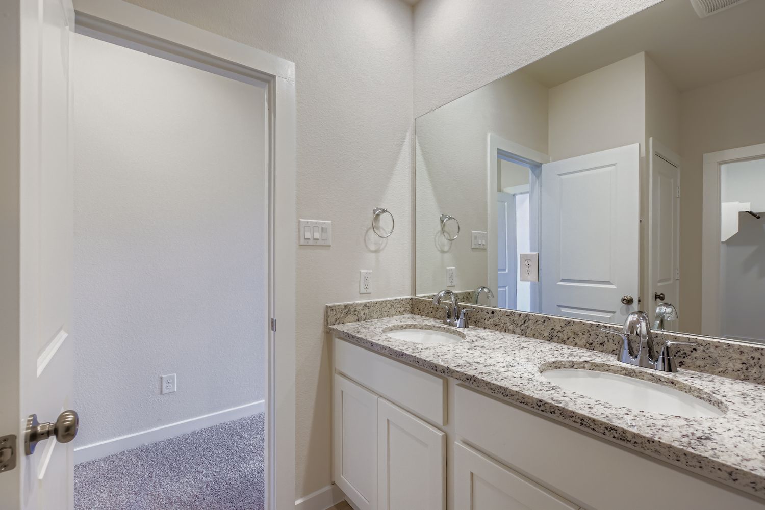 A bathroom with a marble countertop.