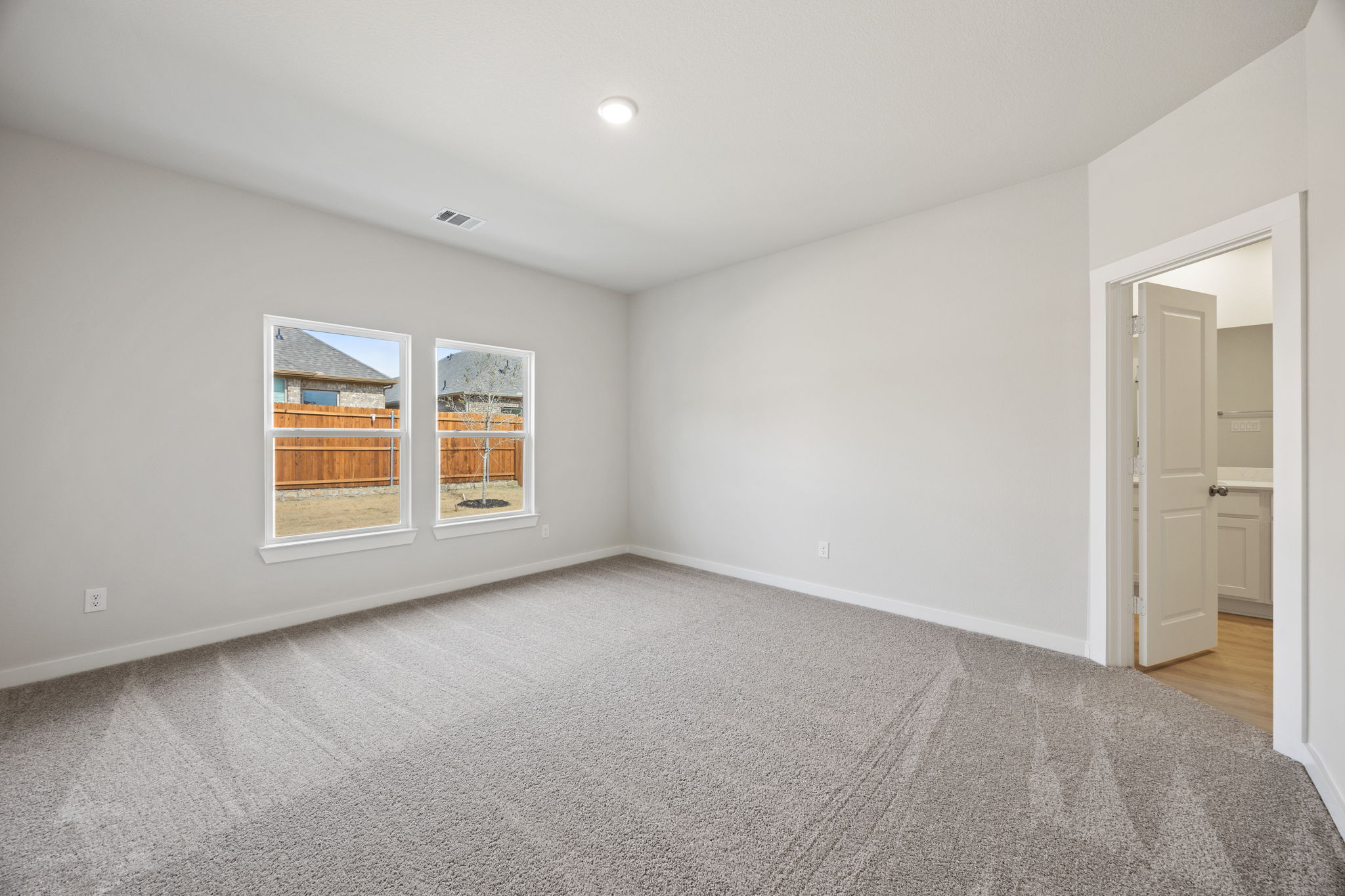 A room with a window and a door.