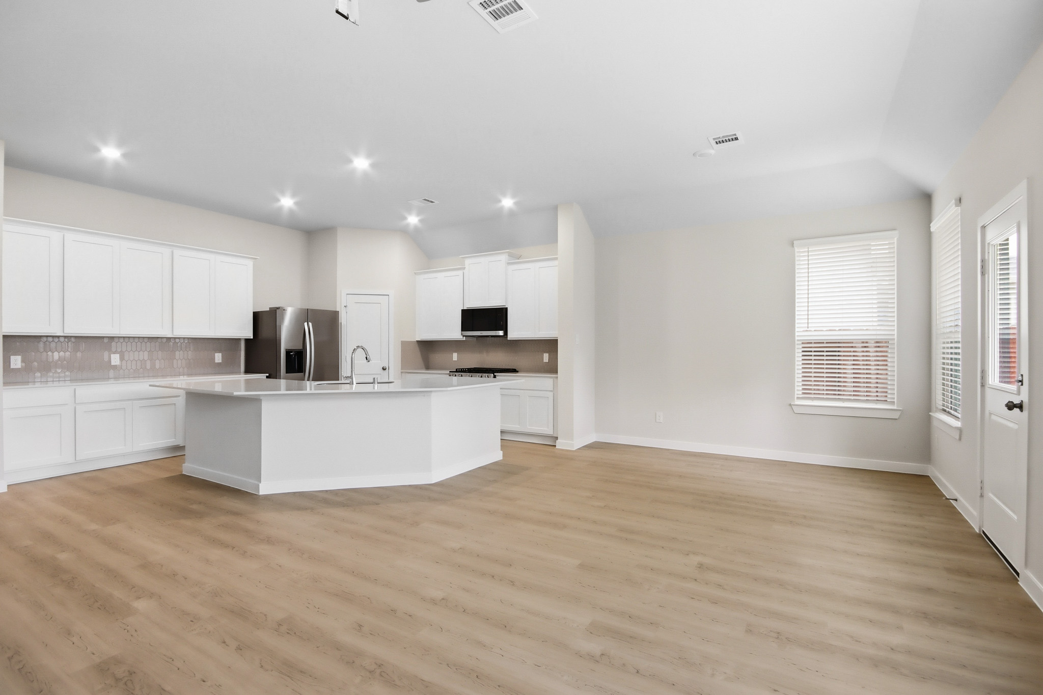 A kitchen with white cabinets.