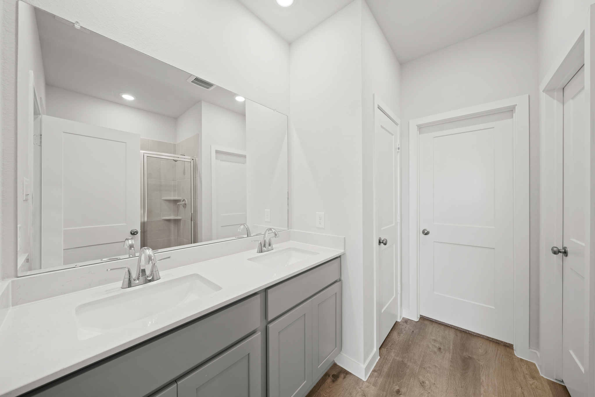 A bathroom with white cabinets.