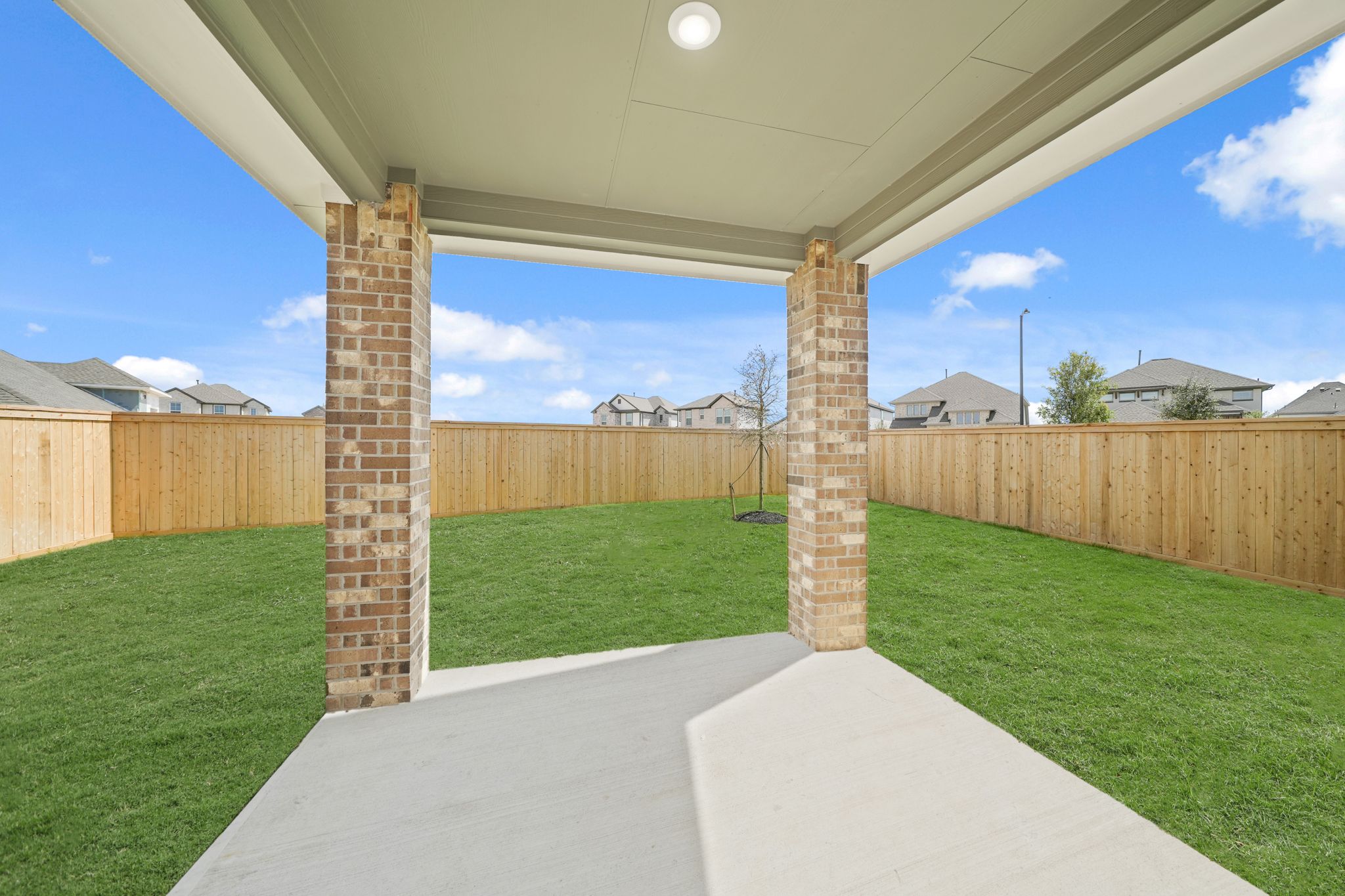 A backyard with a brick wall.