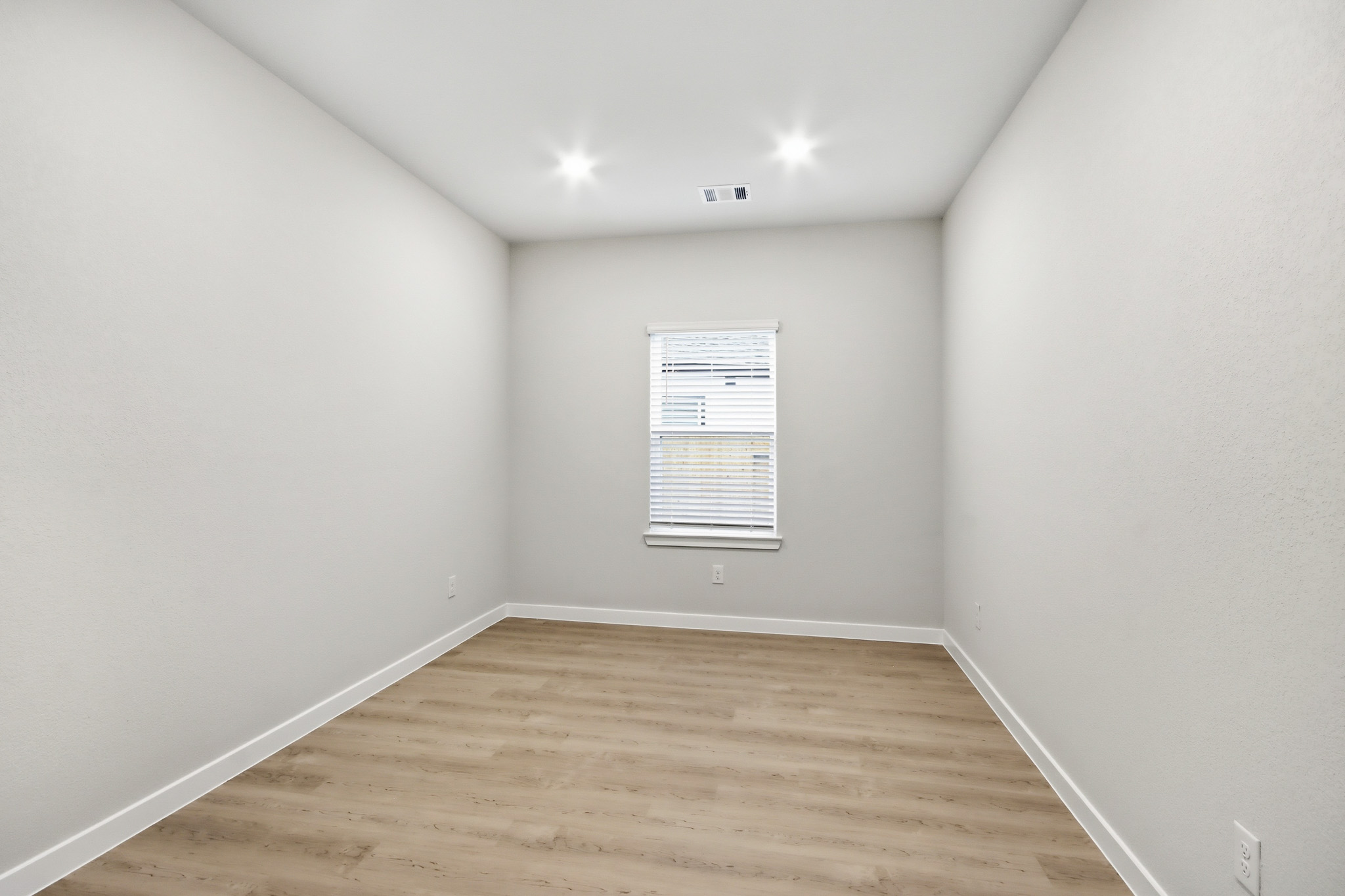 A room with a wood floor and a wood floor.