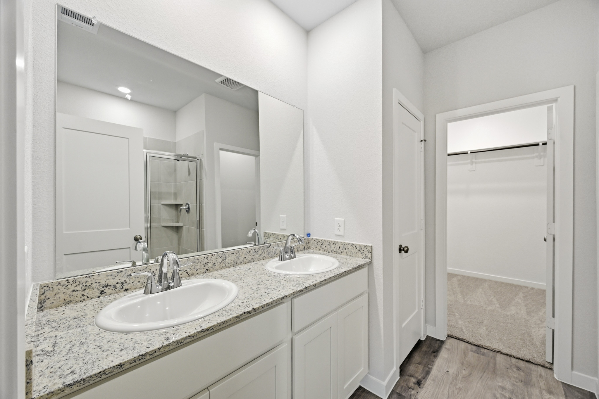 A bathroom with a large mirror.