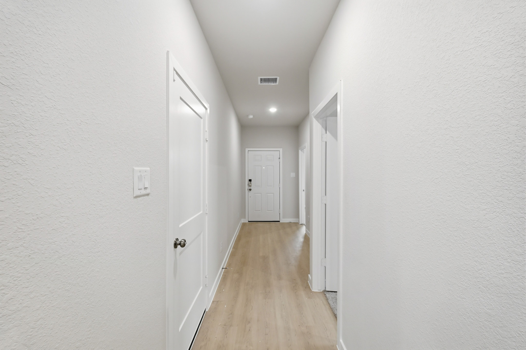 A hallway with white doors.