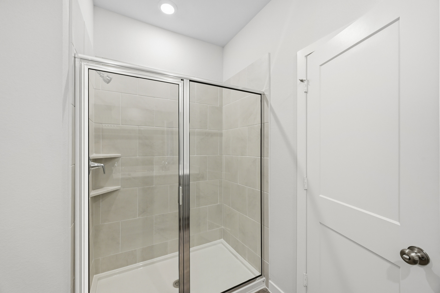 A shower with a glass door.