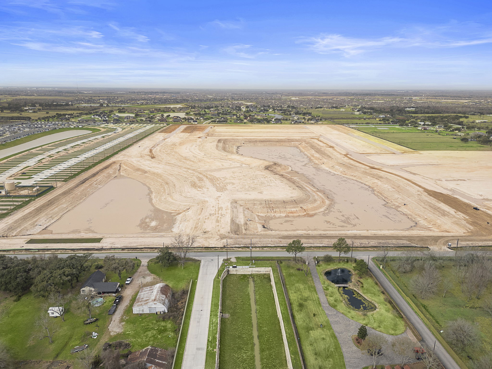 A large field with a road.