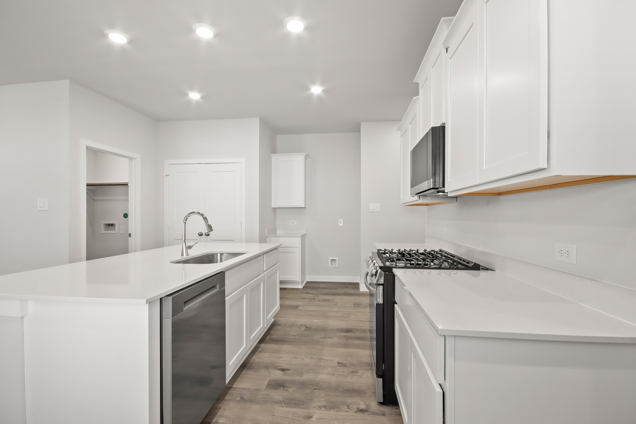 A kitchen with white cabinets.