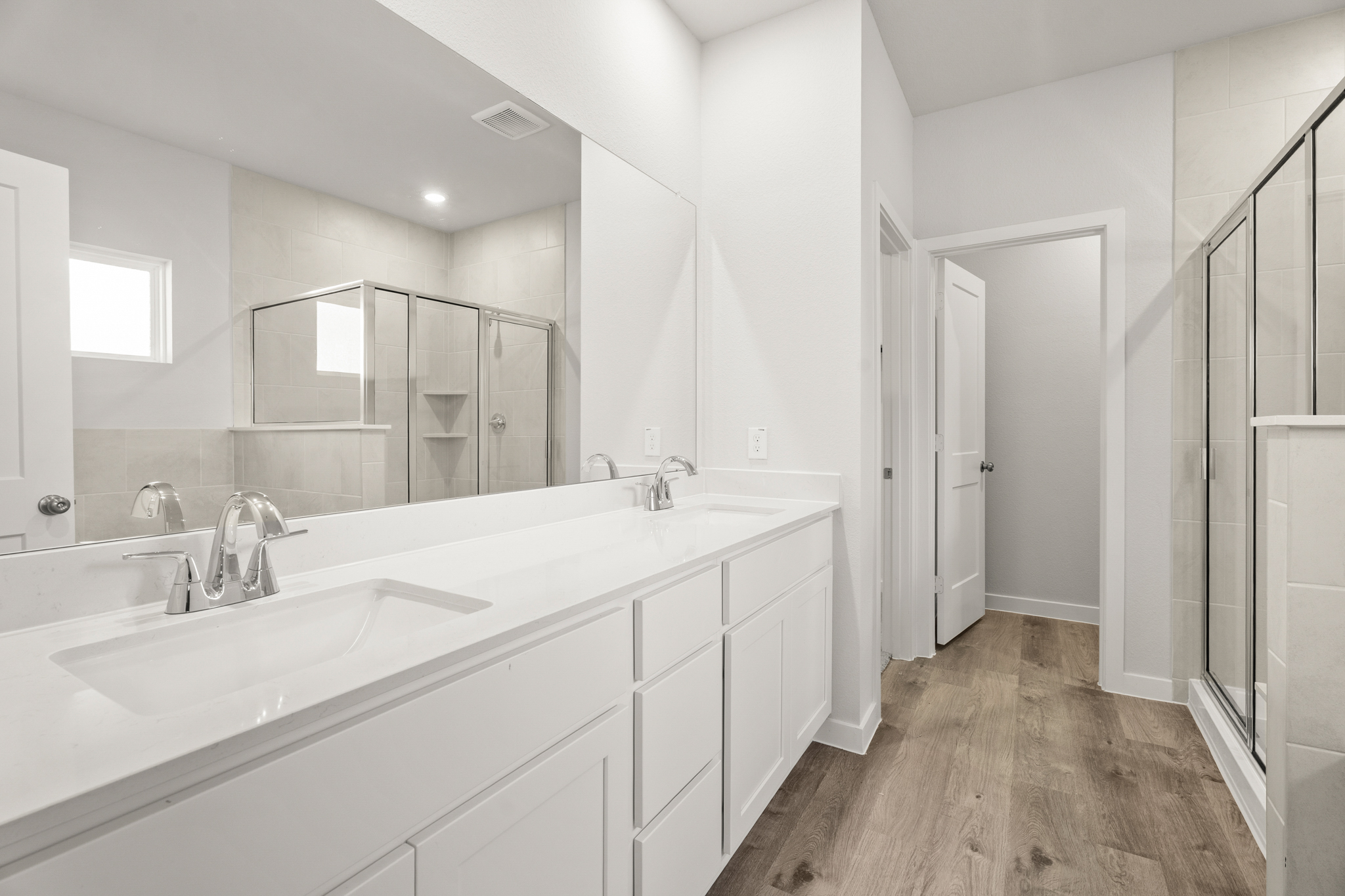 A bathroom with a large mirror.