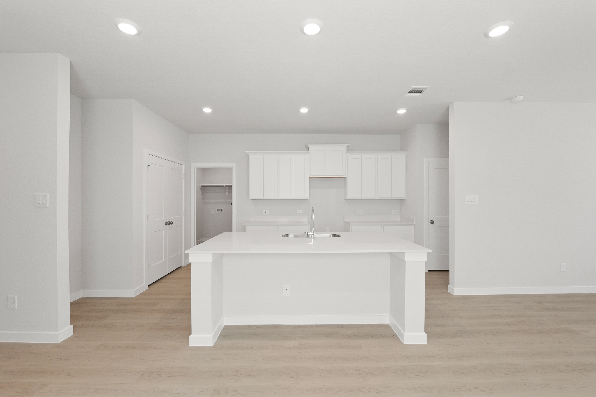 A white kitchen with white cabinets.