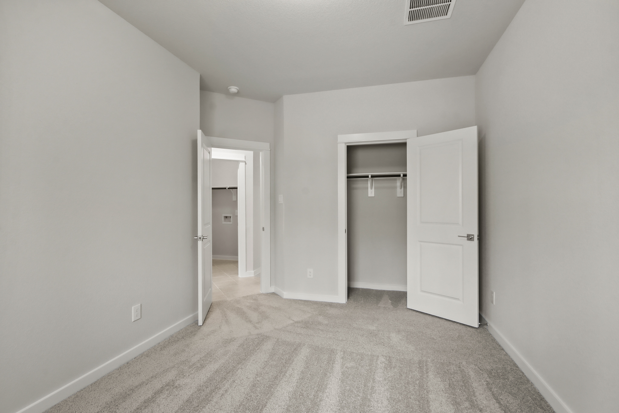 A hallway with white doors.