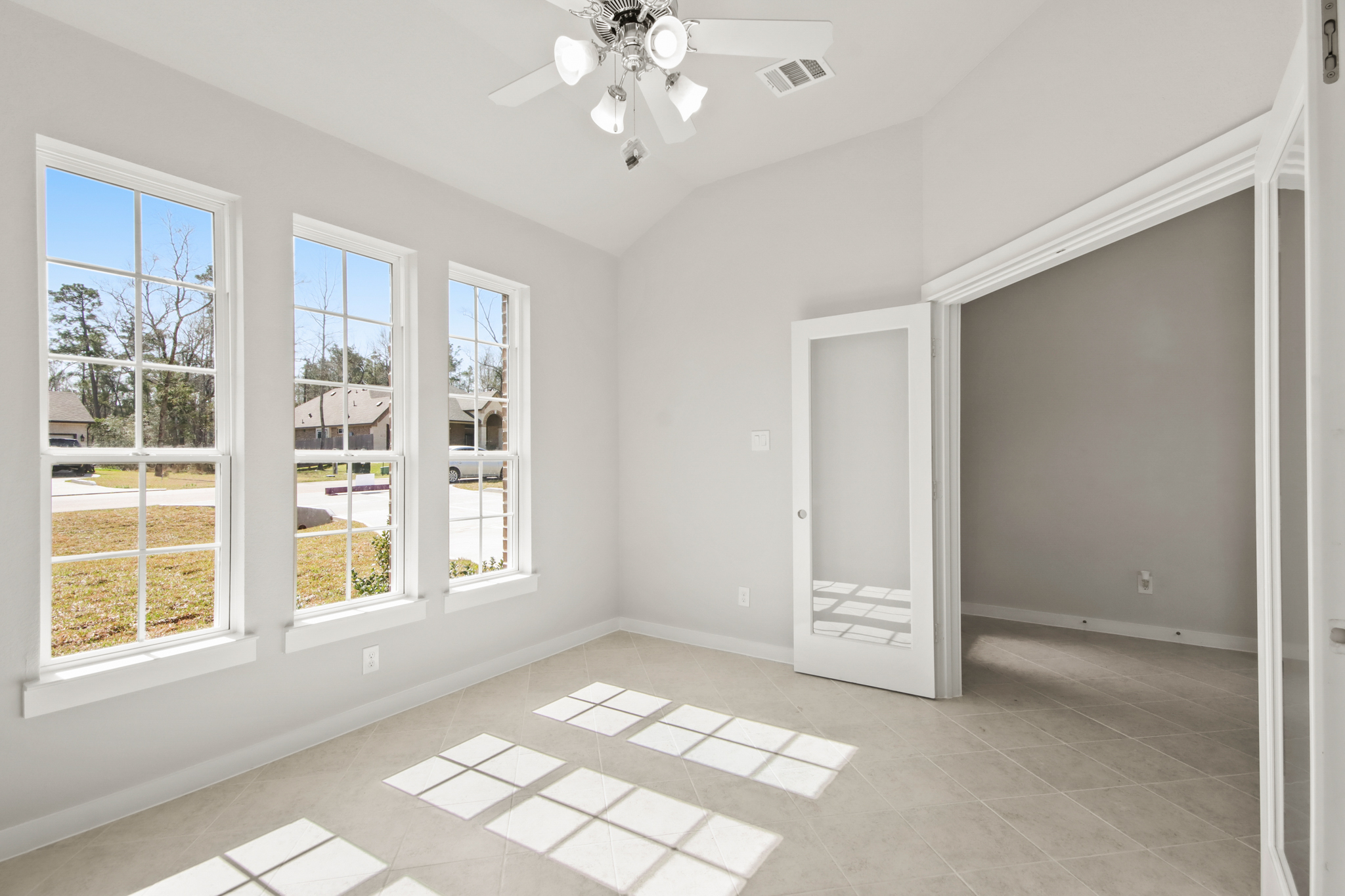 A room with a tile floor and windows.