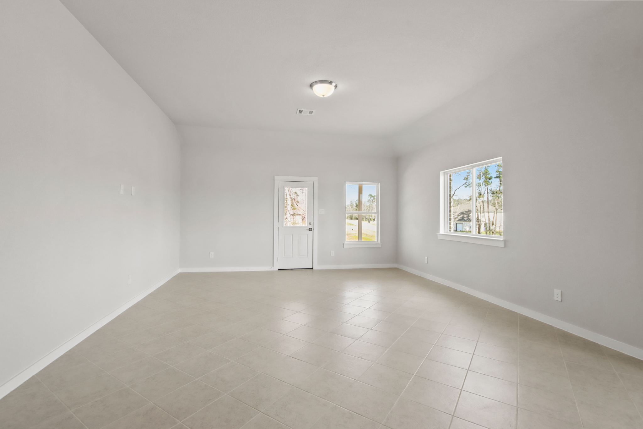 A room with white walls and windows.
