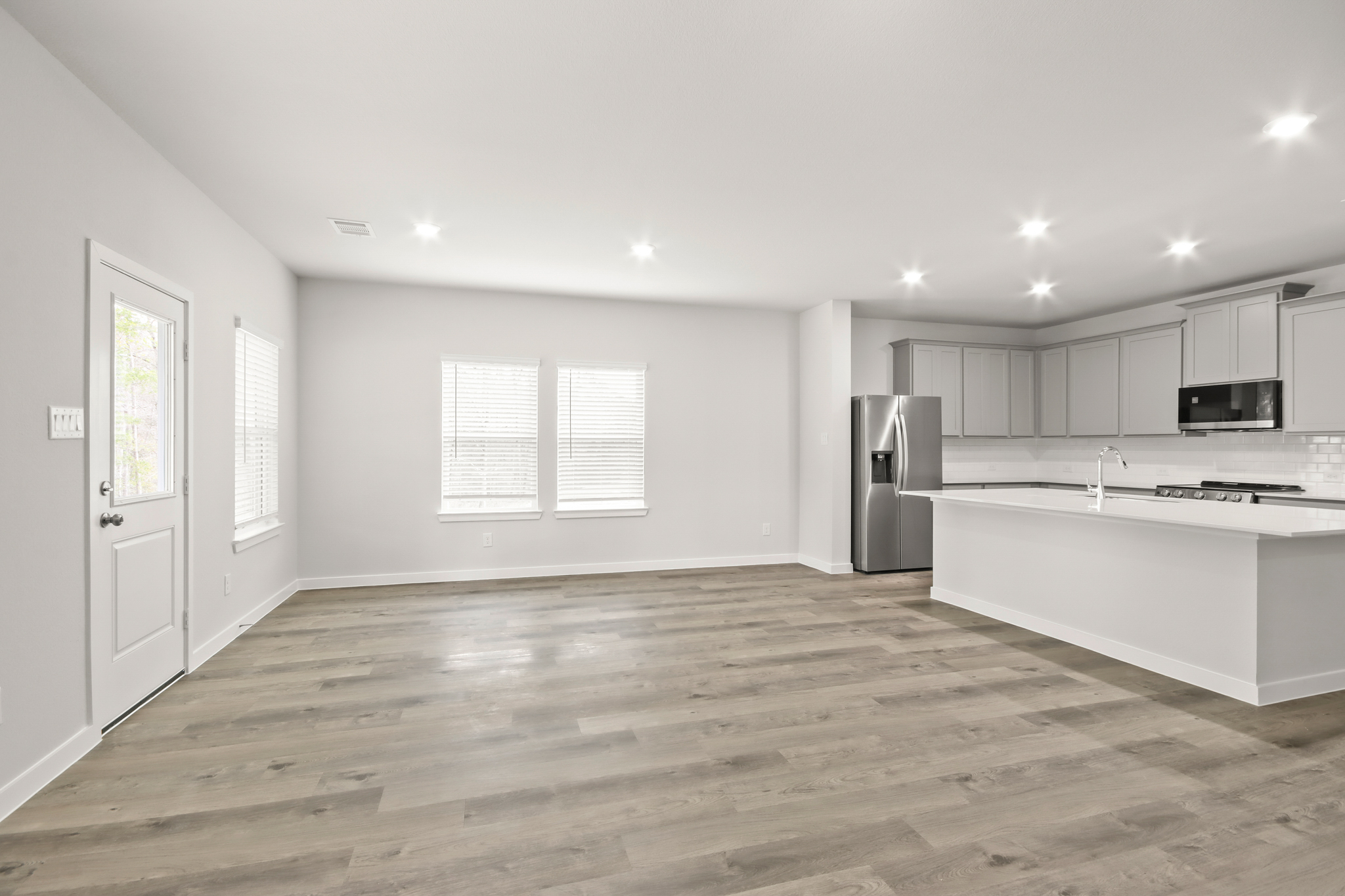 A kitchen with white cabinets.