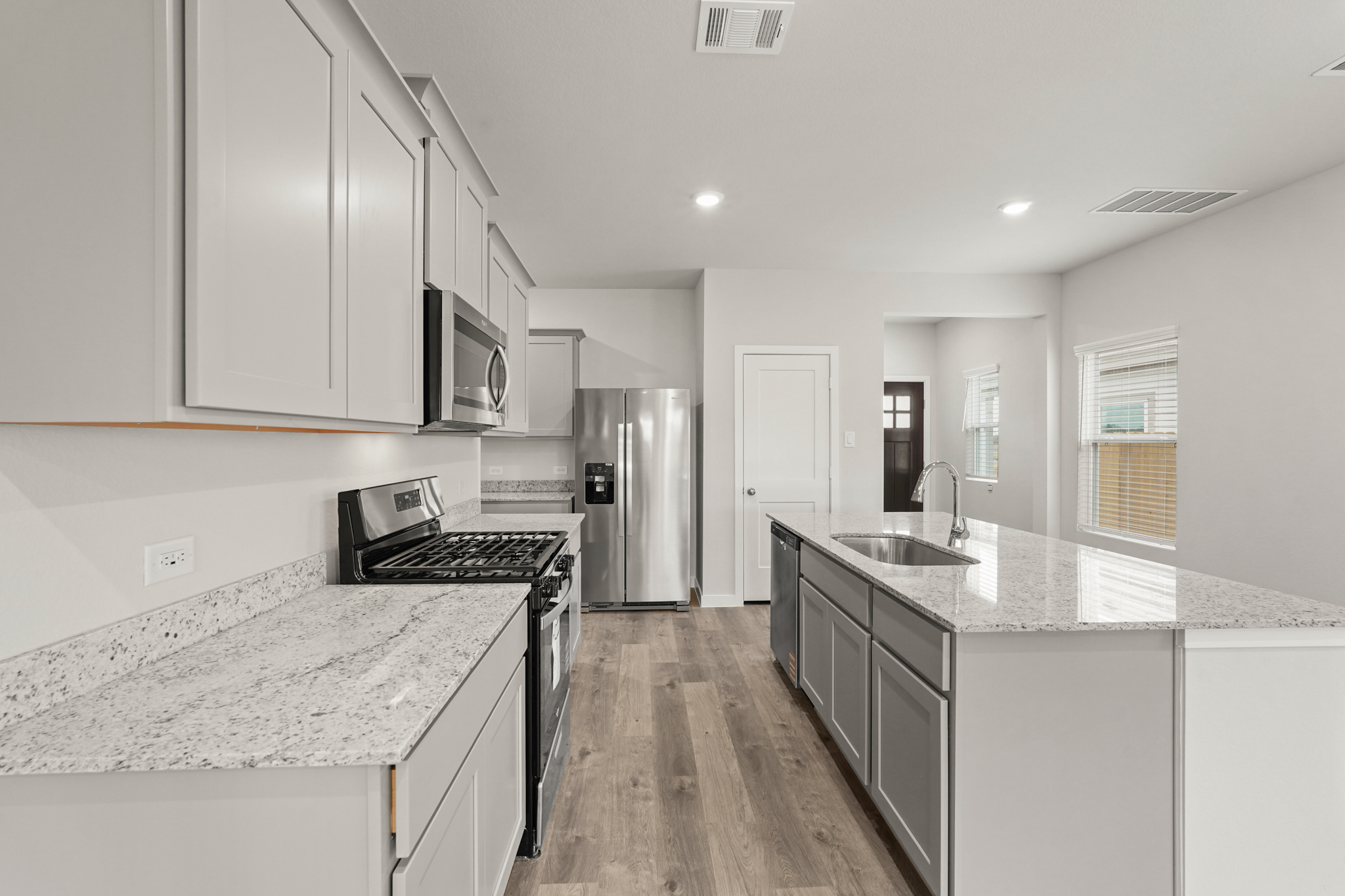 A kitchen with white cabinets.