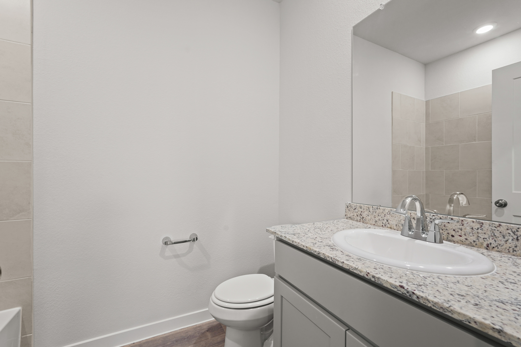 A bathroom with a marble countertop.