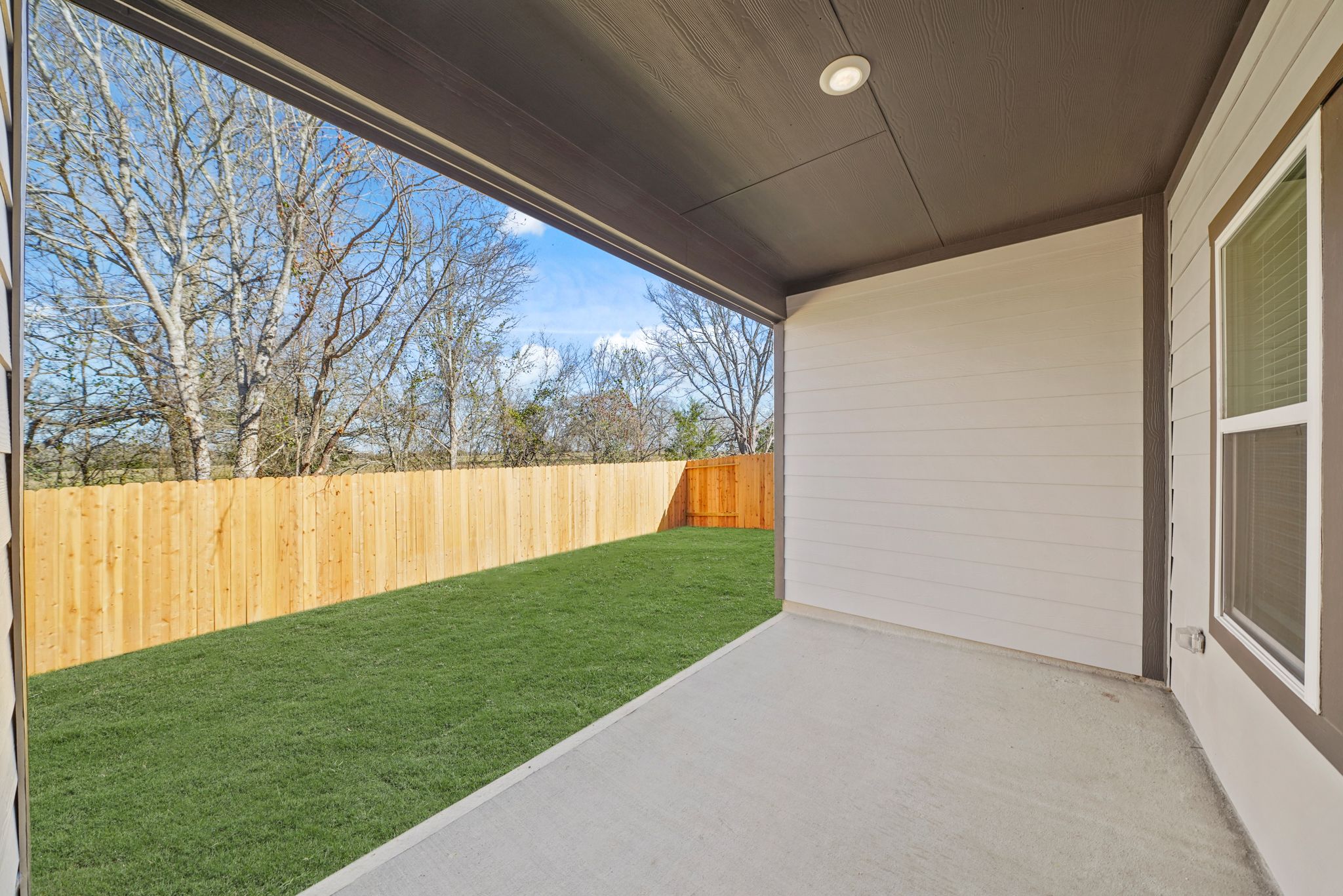 A backyard with a fence and a wood fence.