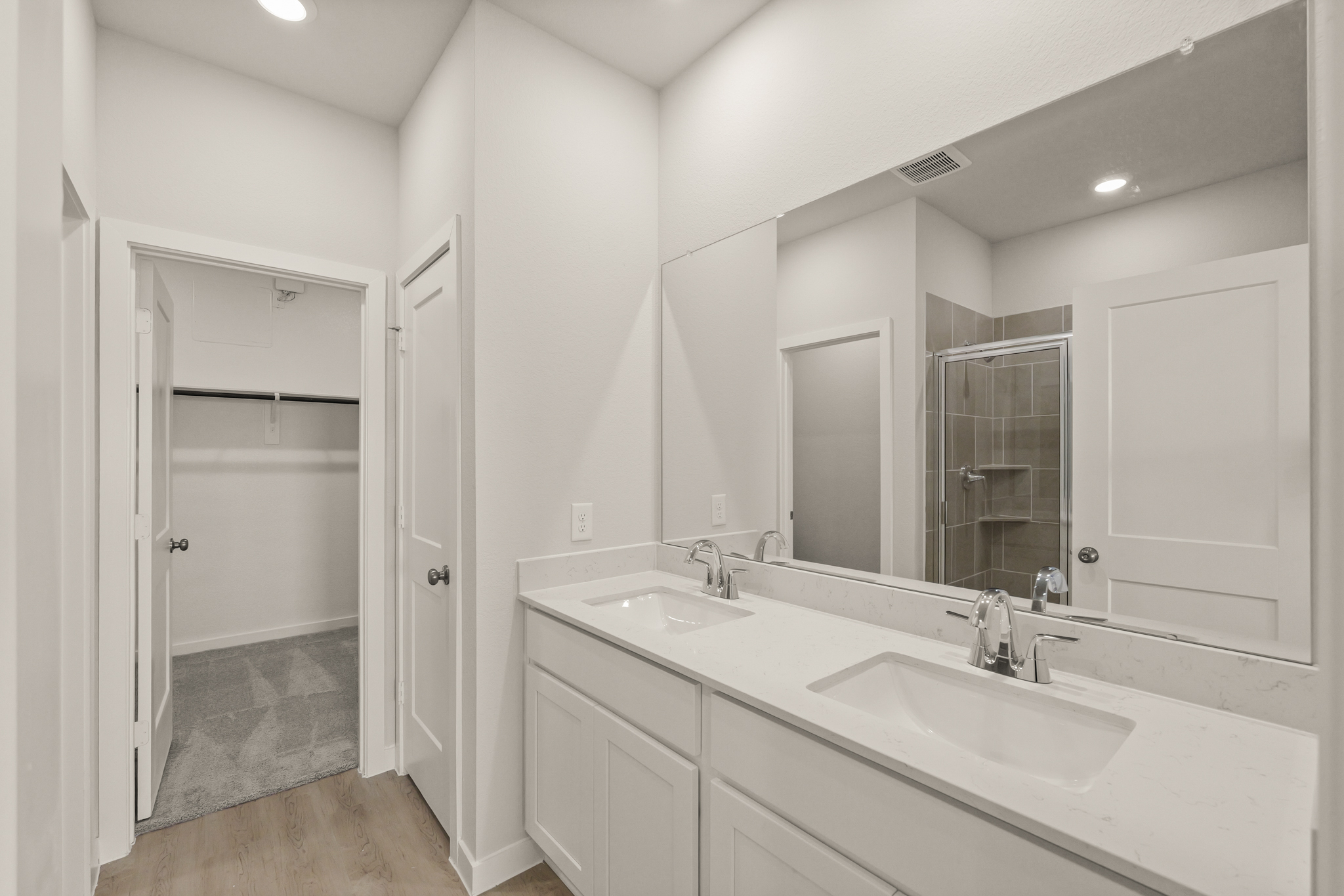 A bathroom with a large mirror.
