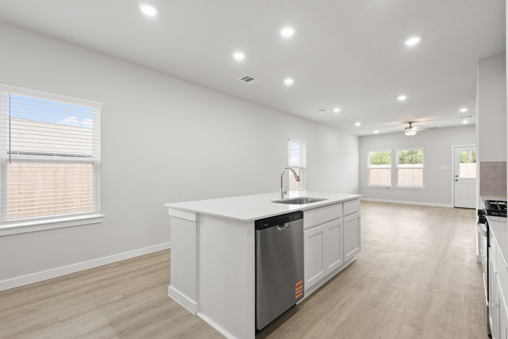 A kitchen with white cabinets.