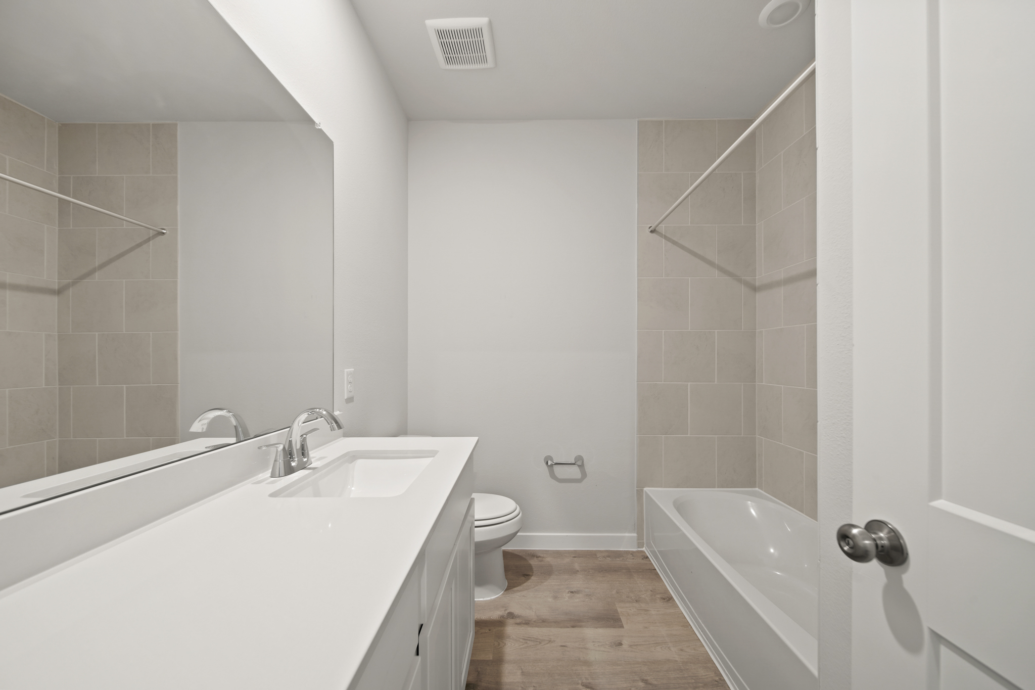 A bathroom with a tub sink and toilet.