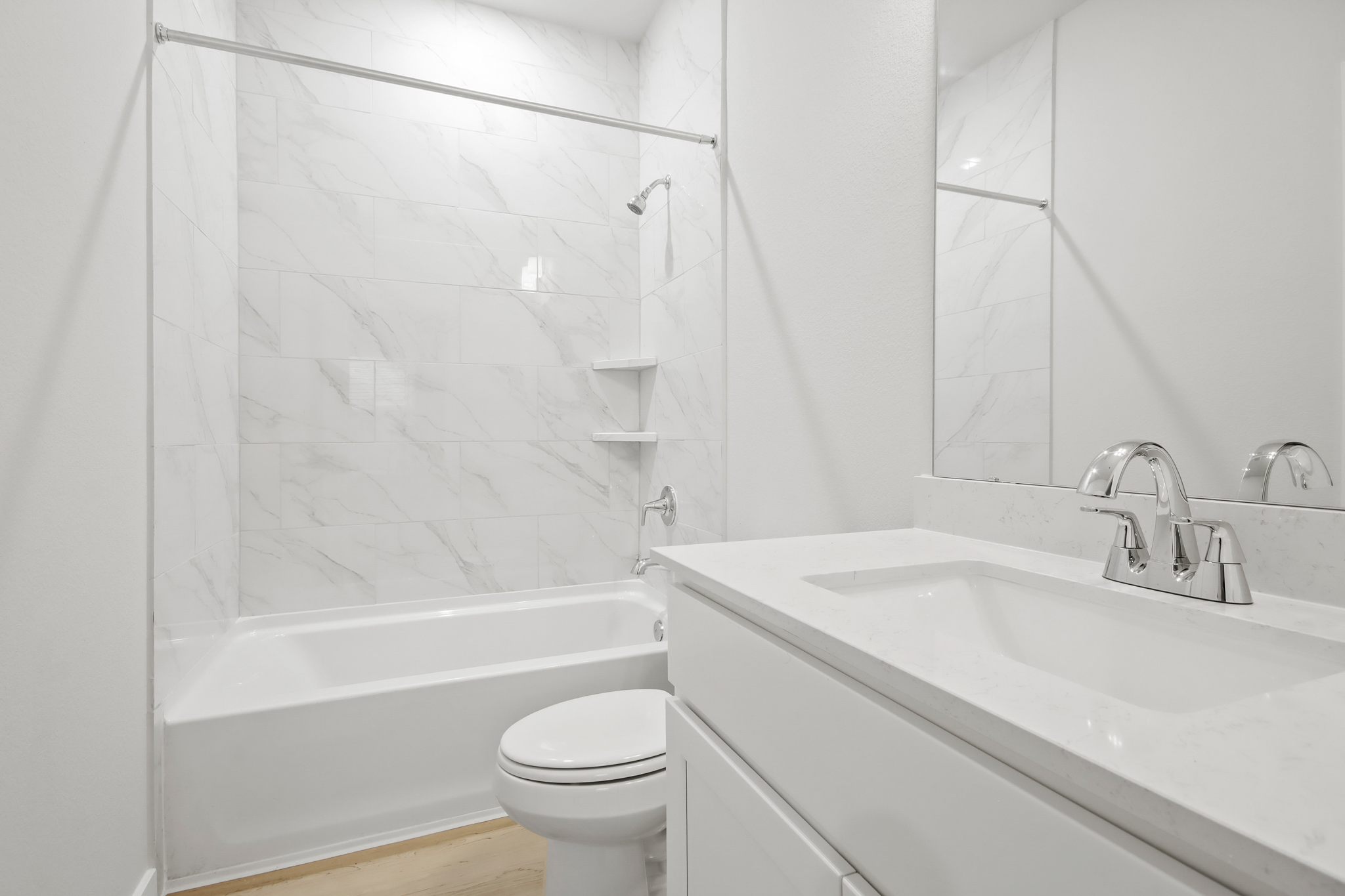 A bathroom with a tub sink and toilet.