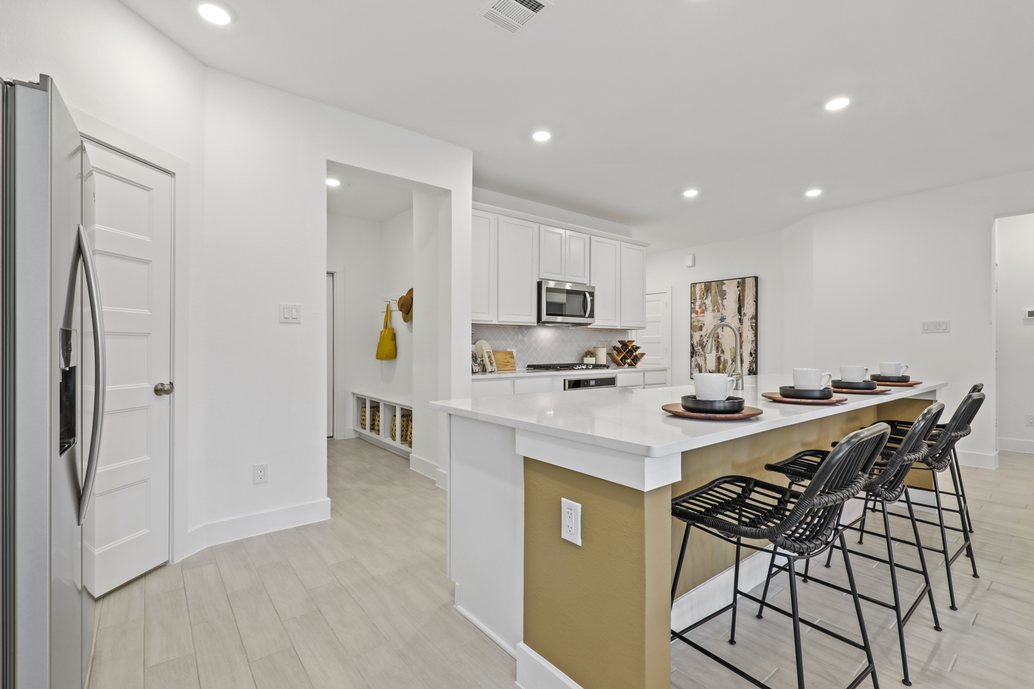 A kitchen with white cabinets.