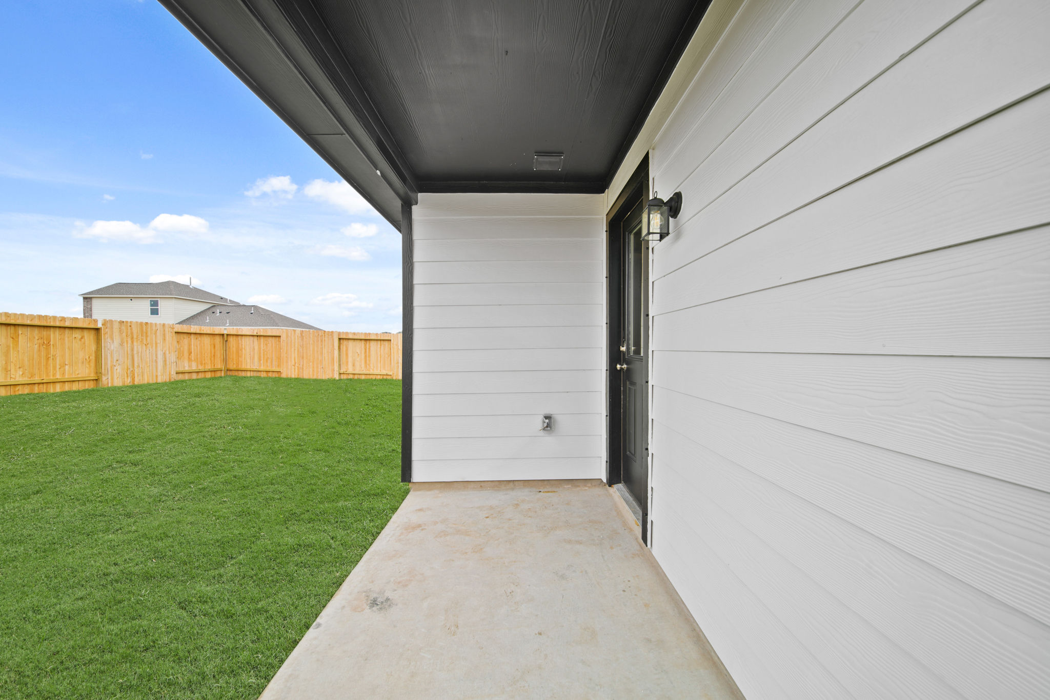 A garage with a fence and grass.