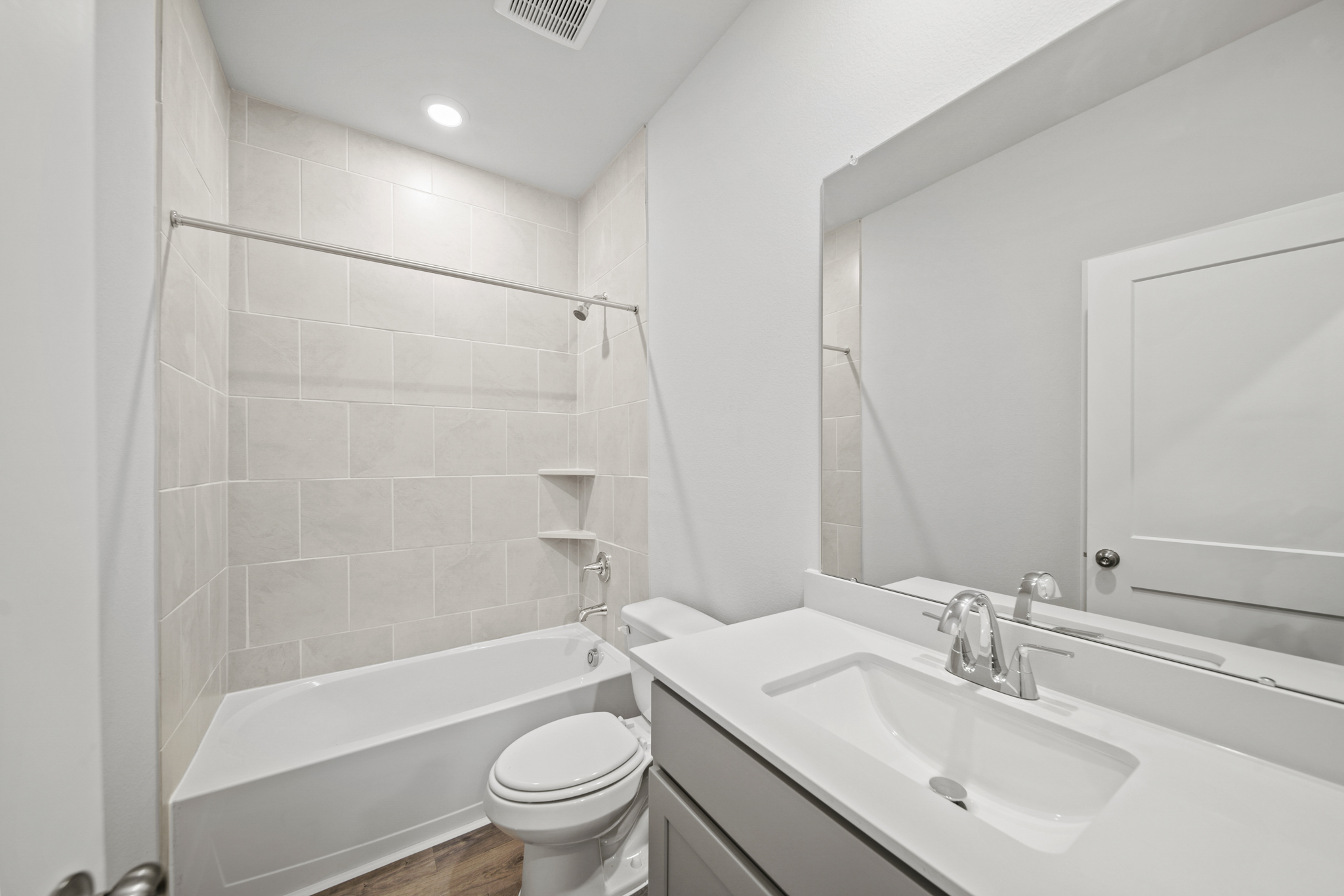 A bathroom with a tub sink and toilet.