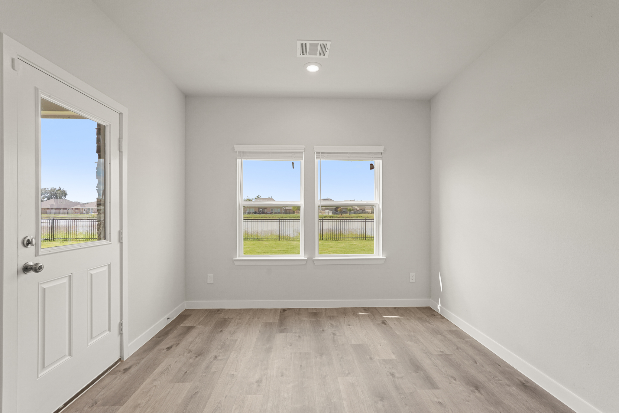 A room with a wood floor and a wood floor with a window and a wood floor with a.