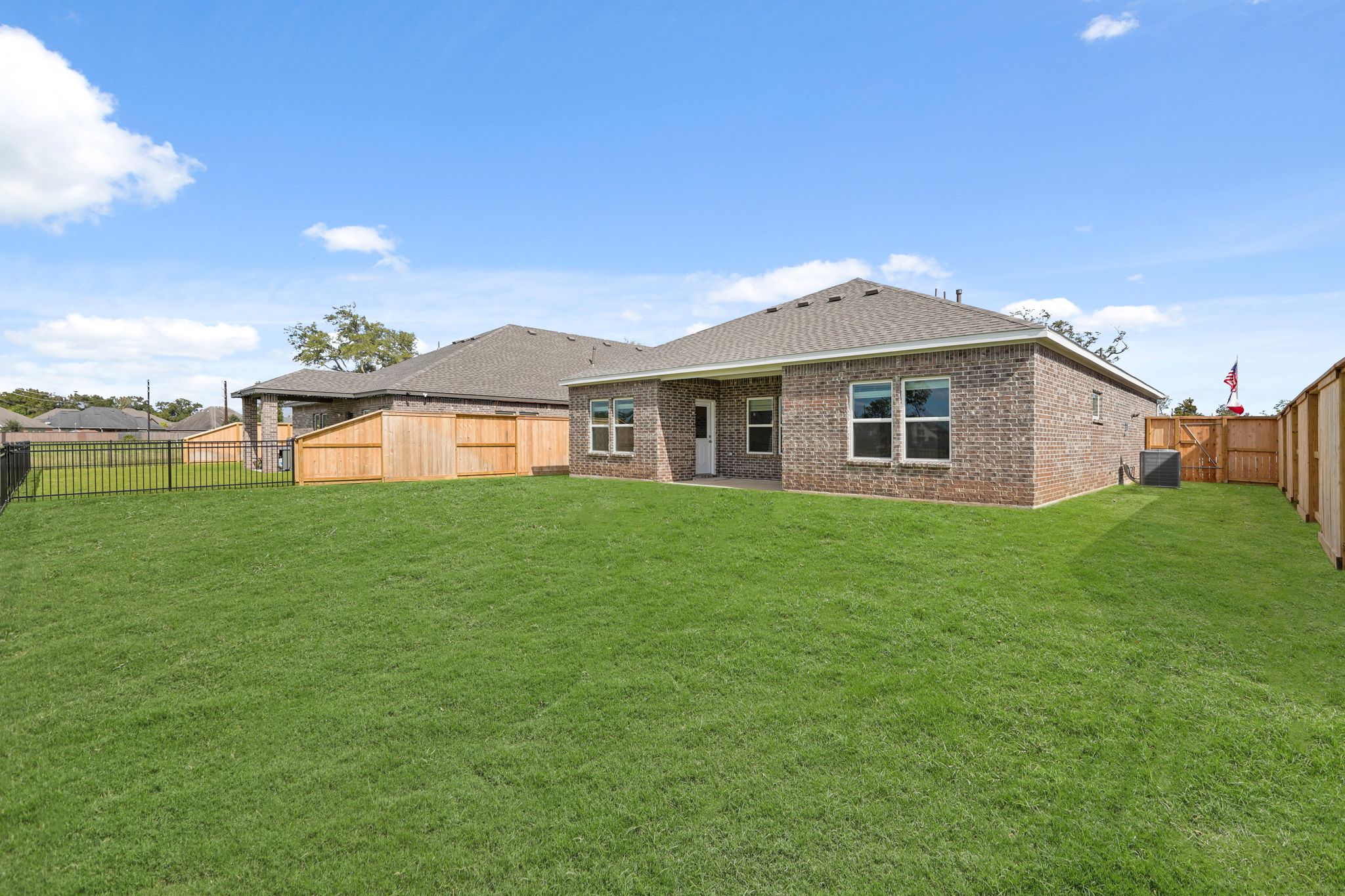 A large green lawn in front of a house.