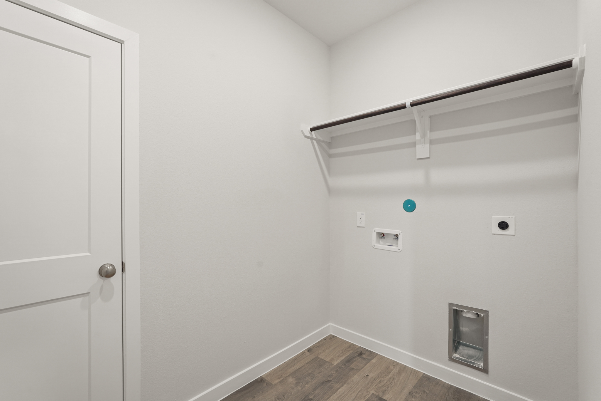 A white wall with a white door.