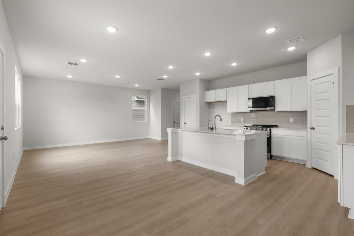 A kitchen with white cabinets.