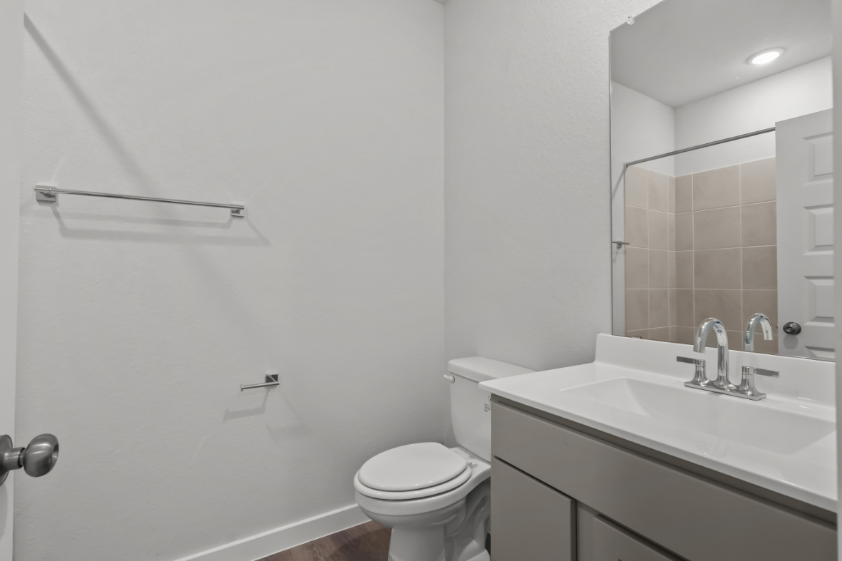 A bathroom with a toilet and sink.