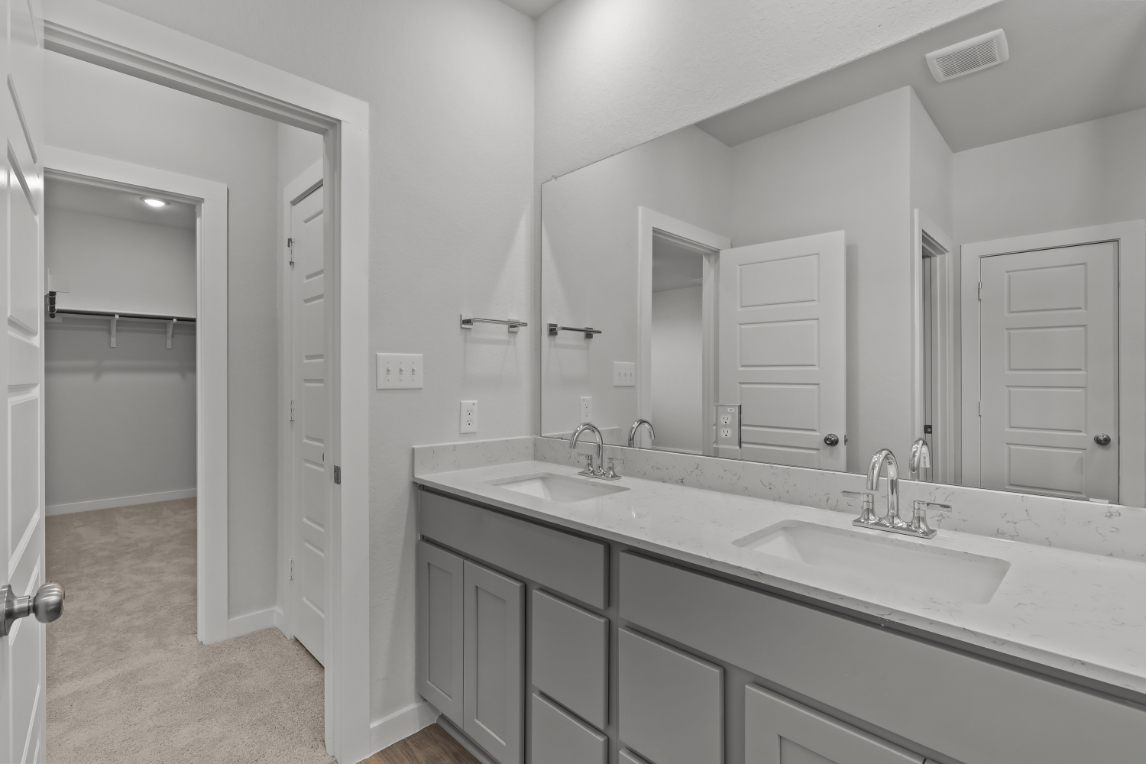 A bathroom with a large mirror.