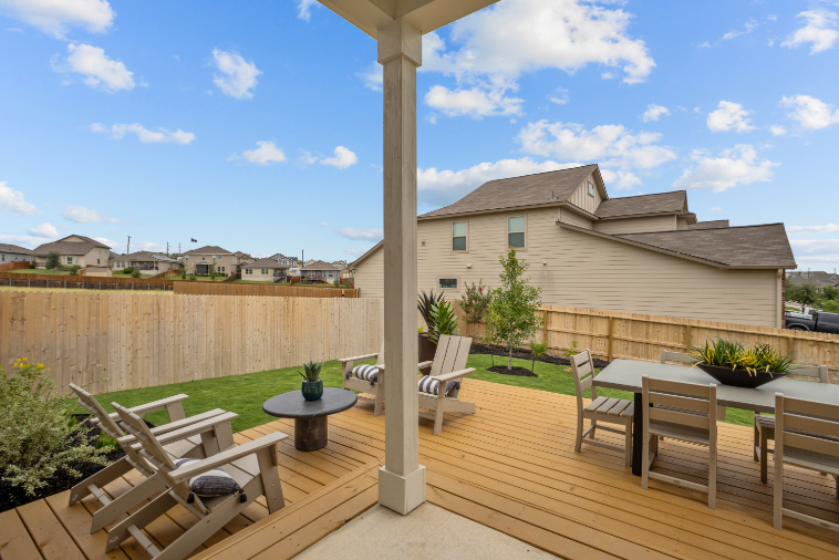 A deck with chairs and a table.