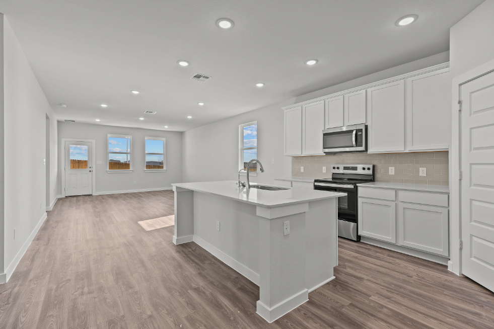 A kitchen with white cabinets.