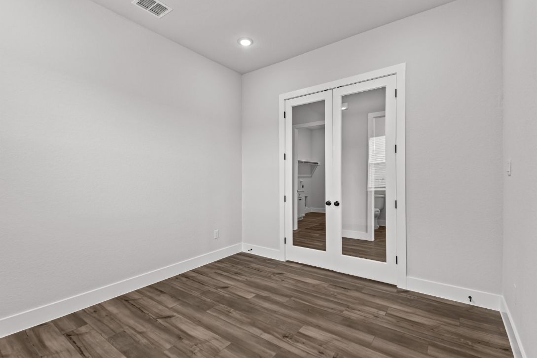 A room with a wood floor and a wood floor.