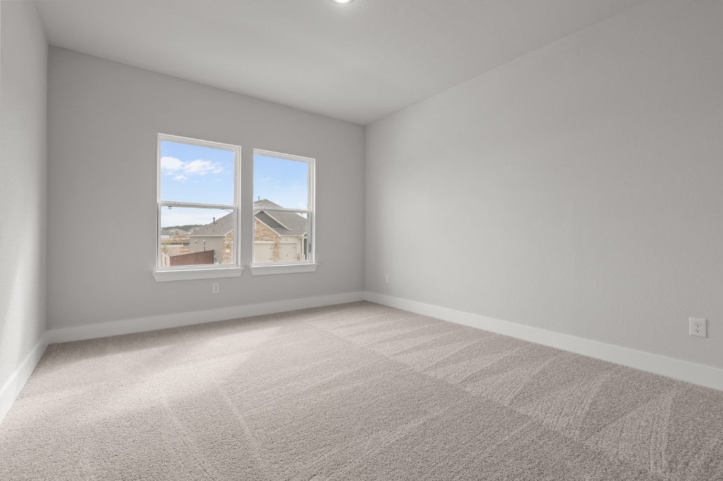 A room with a window and a carpet.