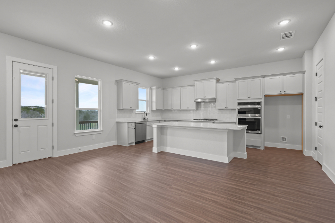 A kitchen with white cabinets.