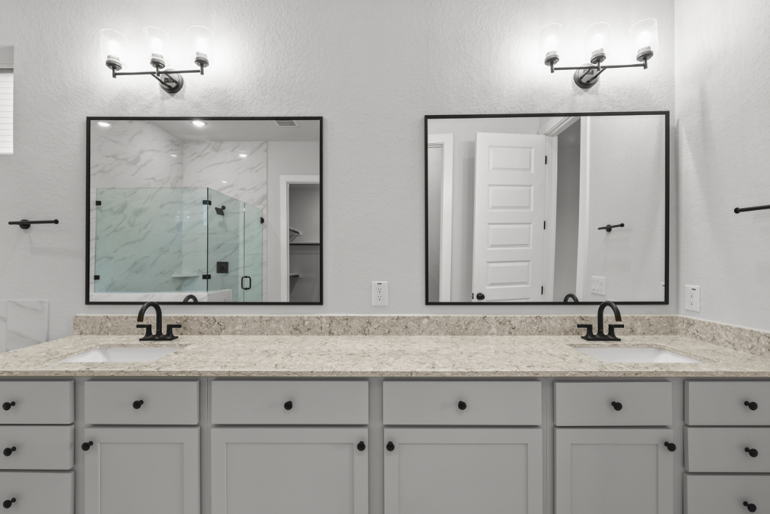 A bathroom with a large mirror.