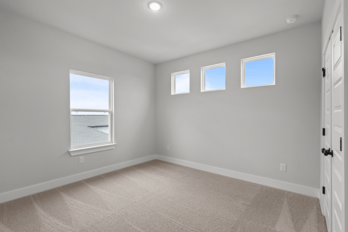 A room with white walls and windows.